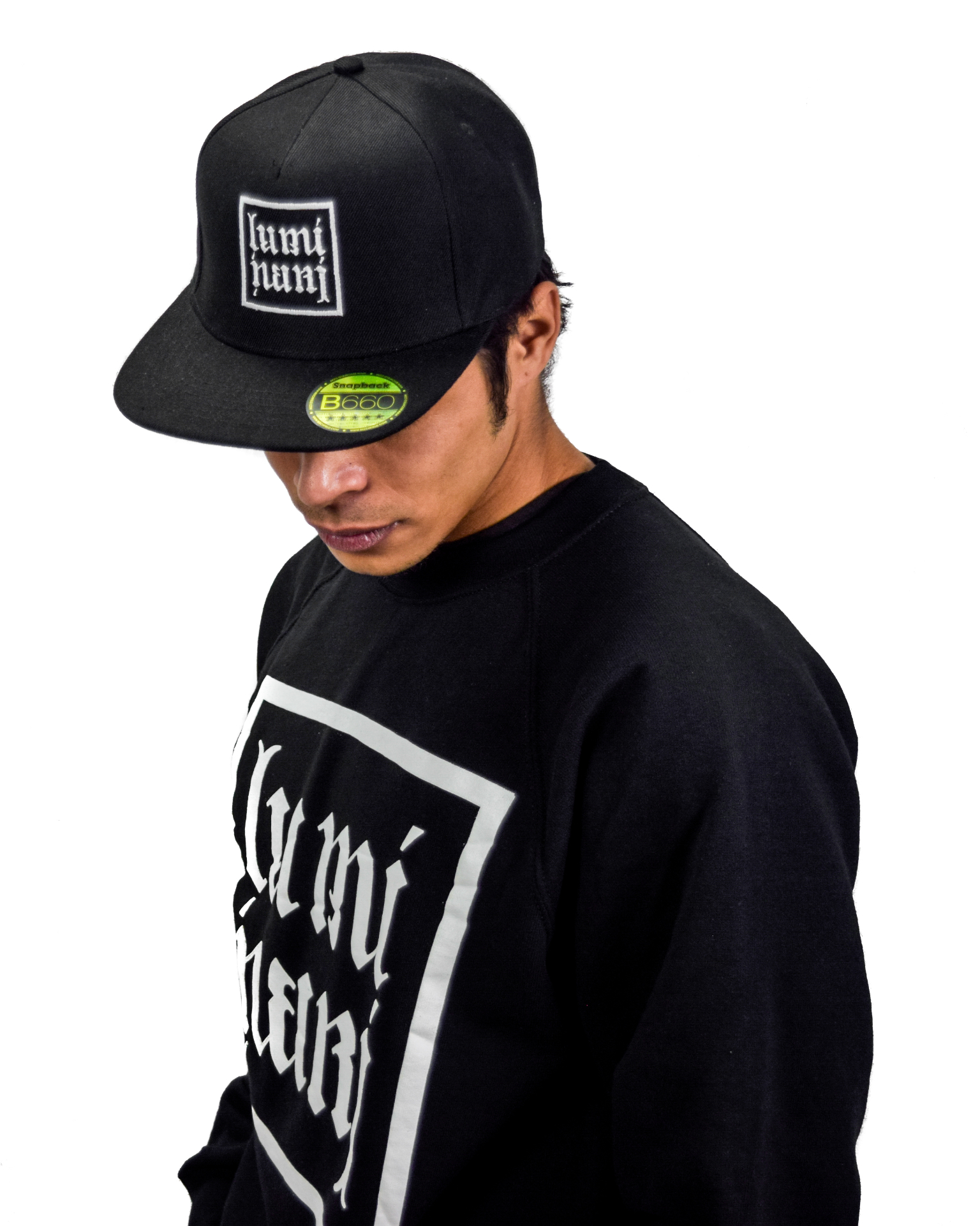 Model wears the original Luminari snapback and crewneck from 2016