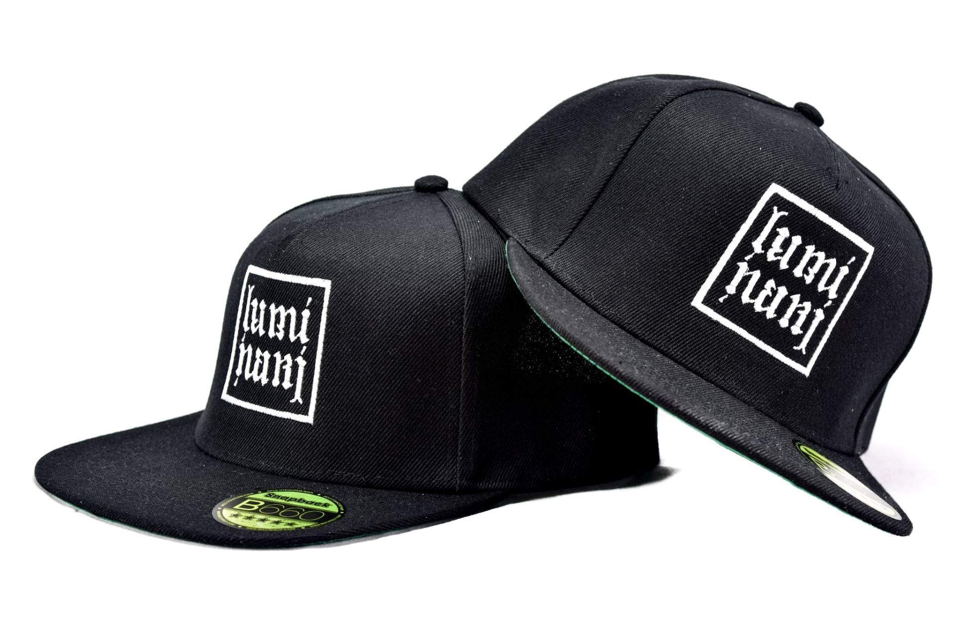 Two black Retro Luminari snapbacks with embroidered white logo from the 2016 archive